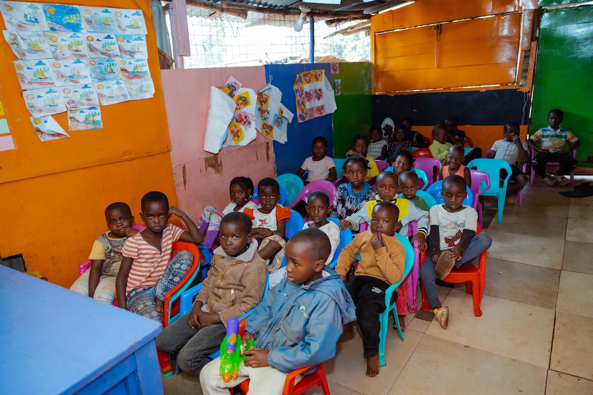 Children seated in a colourful classroom