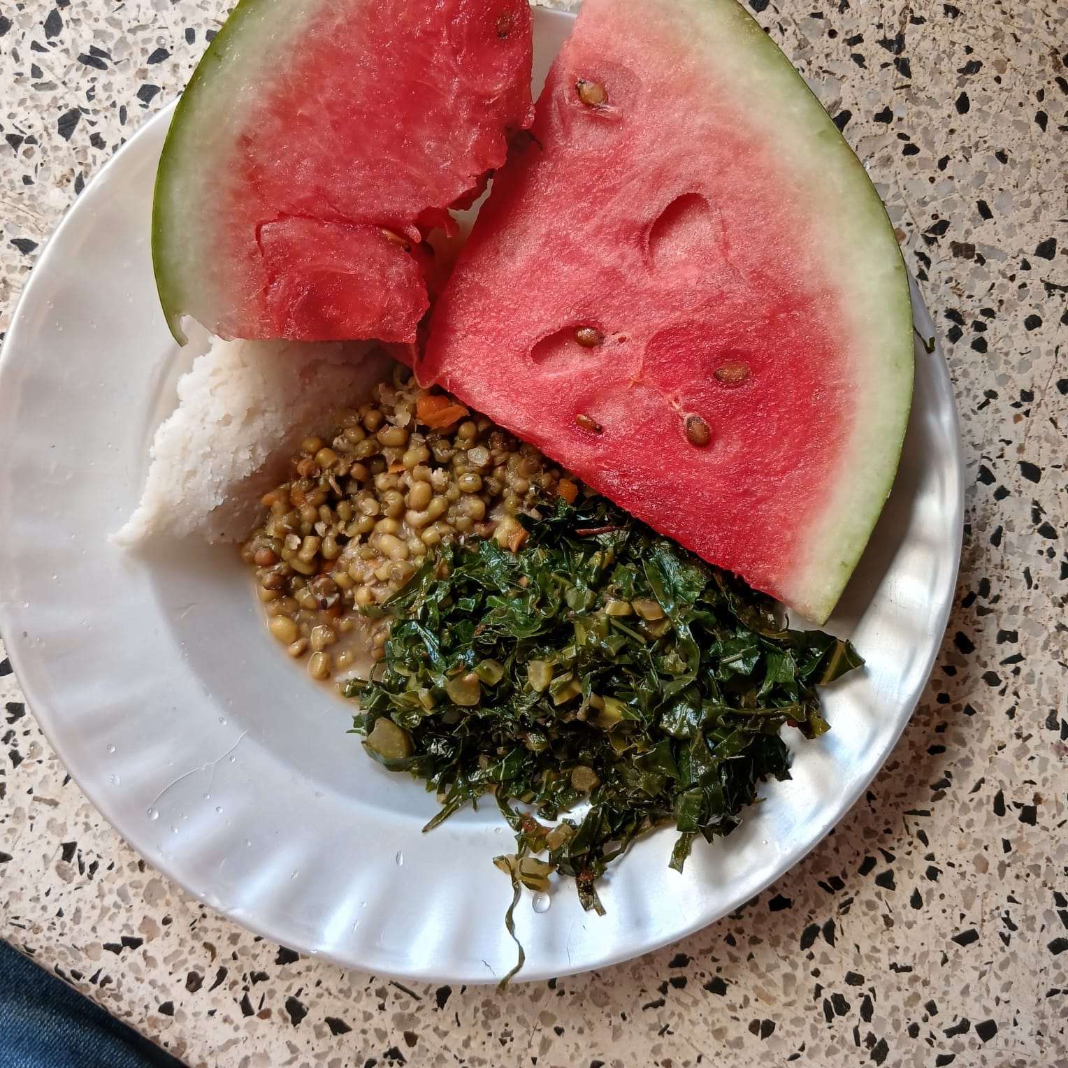 A nutritious plate with grains, greens and watermelon